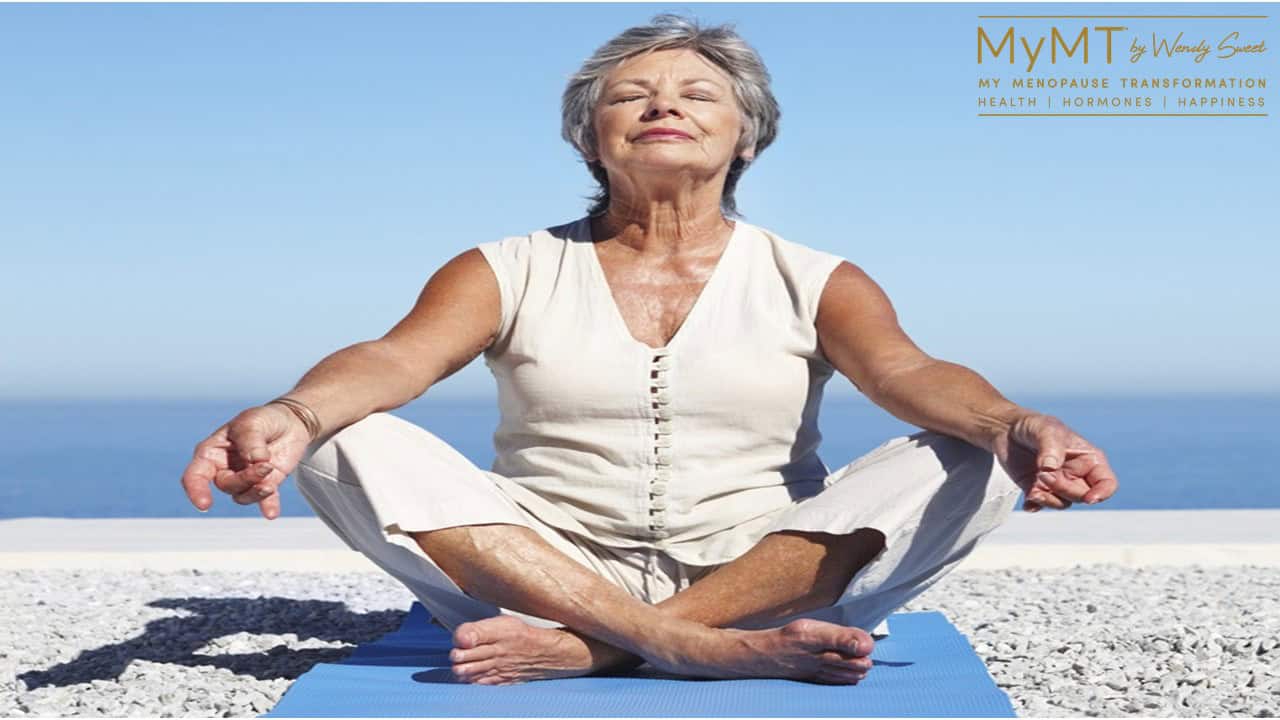 mature lady yoga at the beach