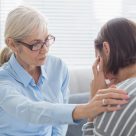 Therapist,Comforting,Patient,On,Sofa,At,Home Therapist,Comforting,Patient,On,Sofa,At,Home